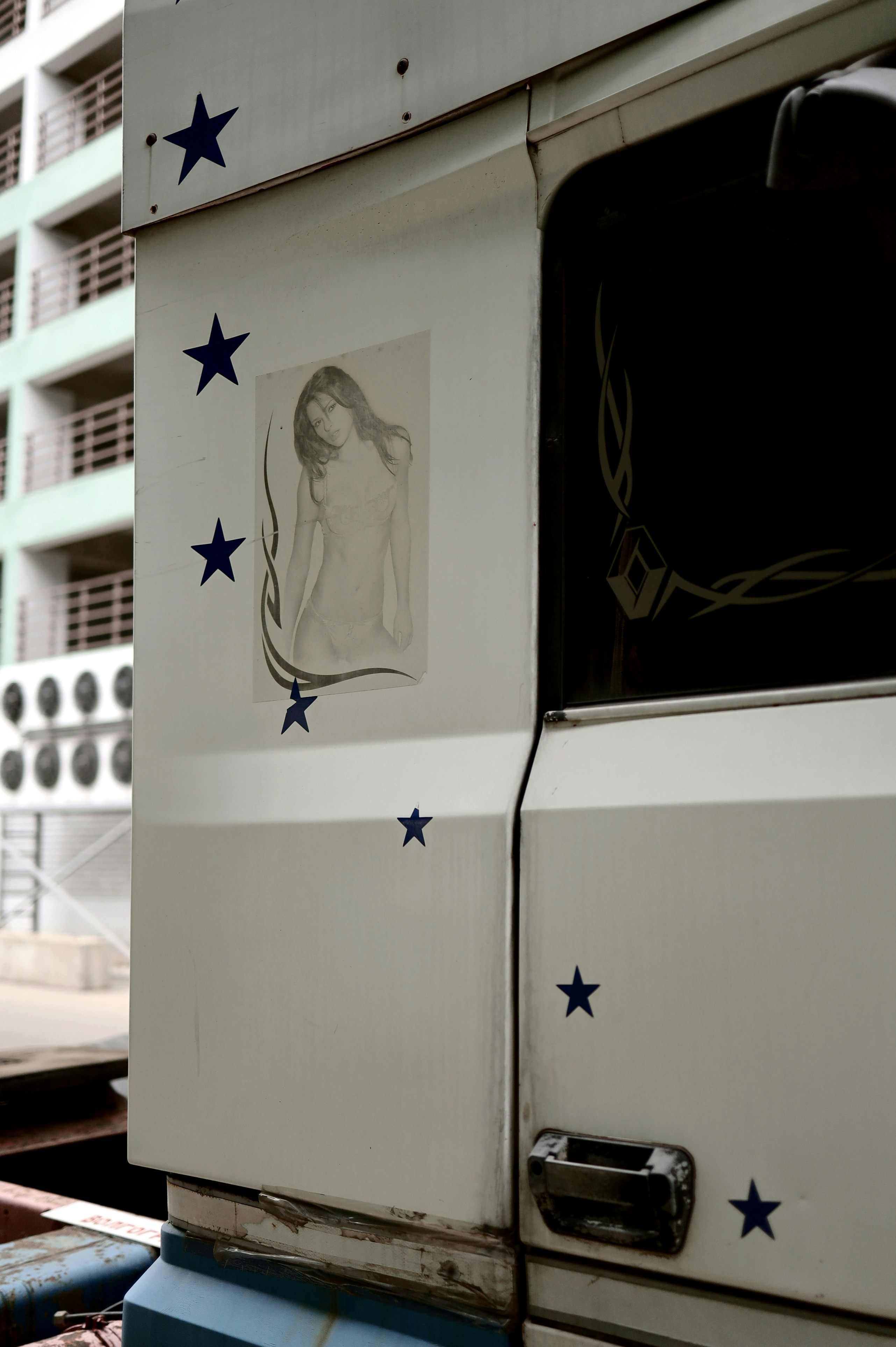 White truck with drawing of woman and stars