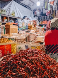 A vibrant market stall filled with dried chilies and spices.