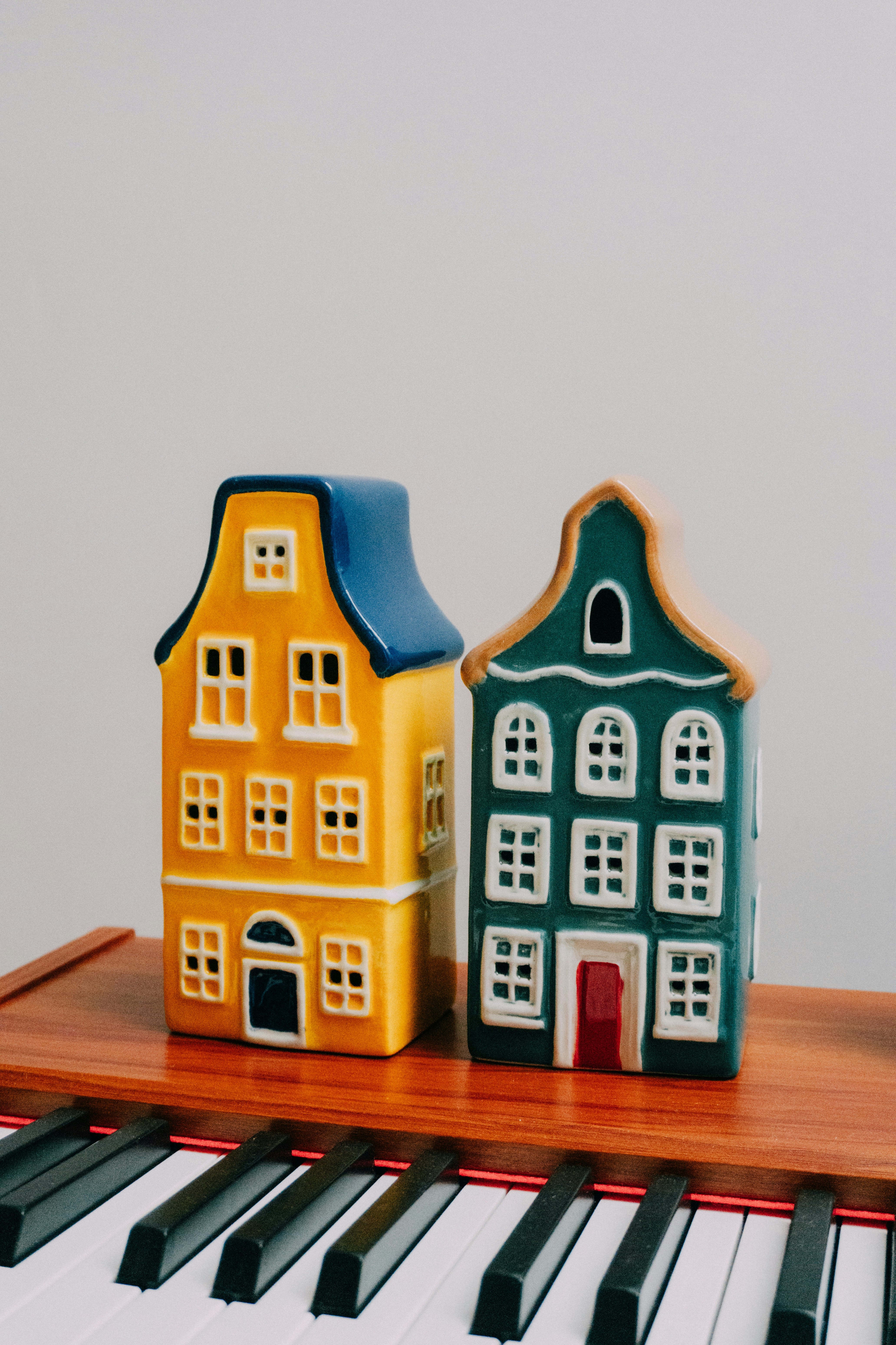 Two decorative houses on a piano keyboard