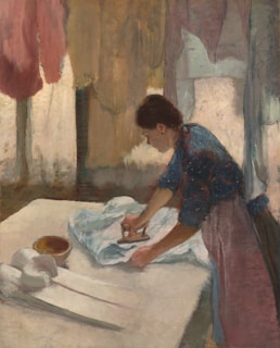 Woman ironing clothes on a large table