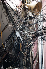 Tangled mass of electrical wires on pole