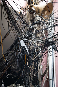 Tangled mass of electrical wires on pole
