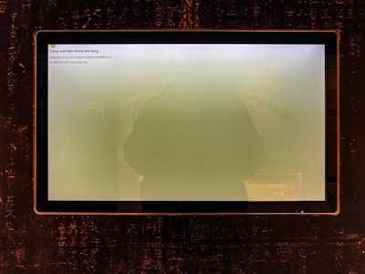 A computer screen shows a hazy green display.