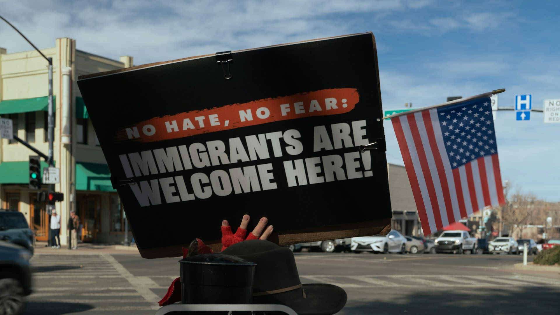 Protest sign reads immigrants are welcome here