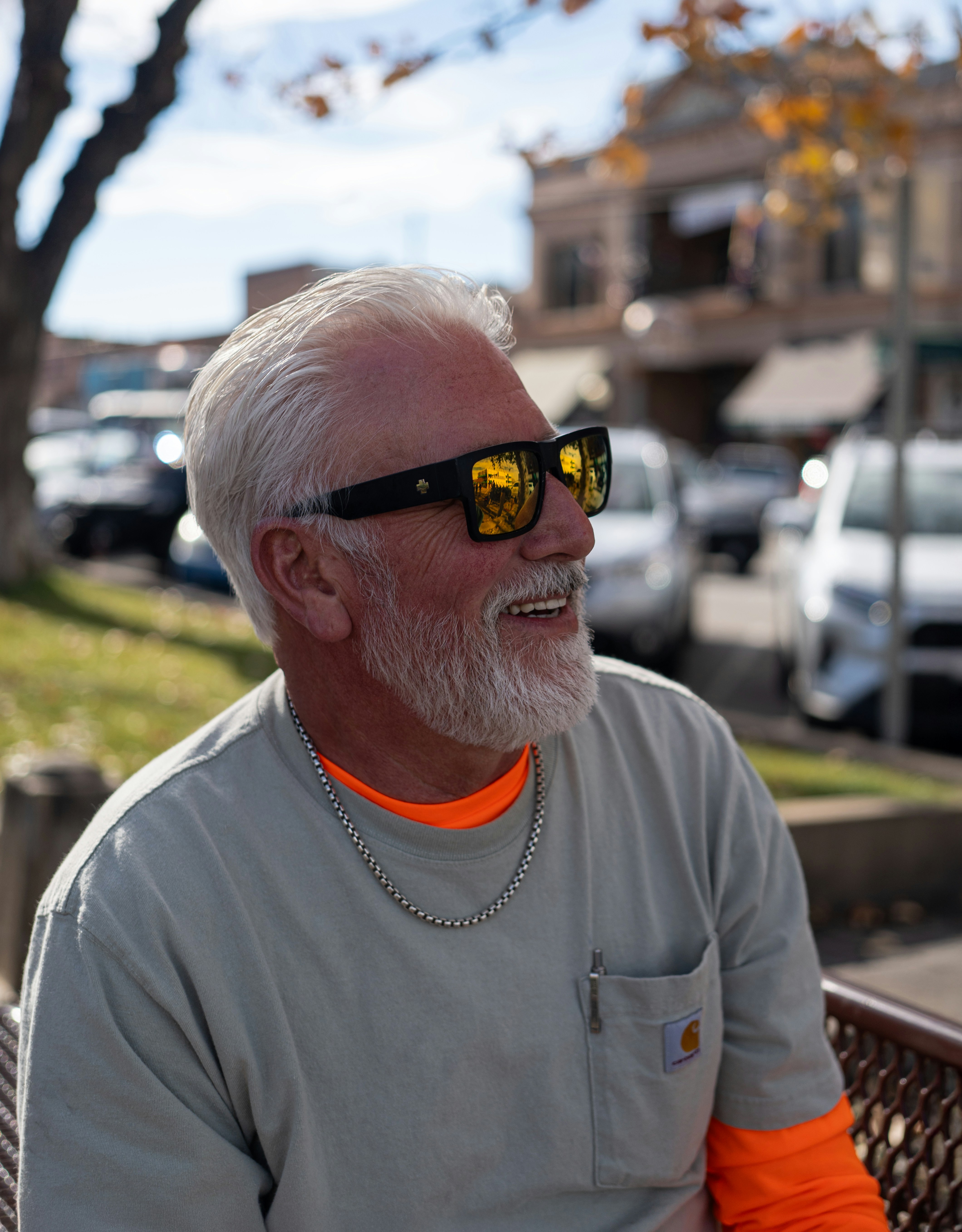 Man with white hair and beard wearing sunglasses