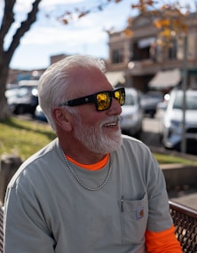 Man with white hair and beard wearing sunglasses