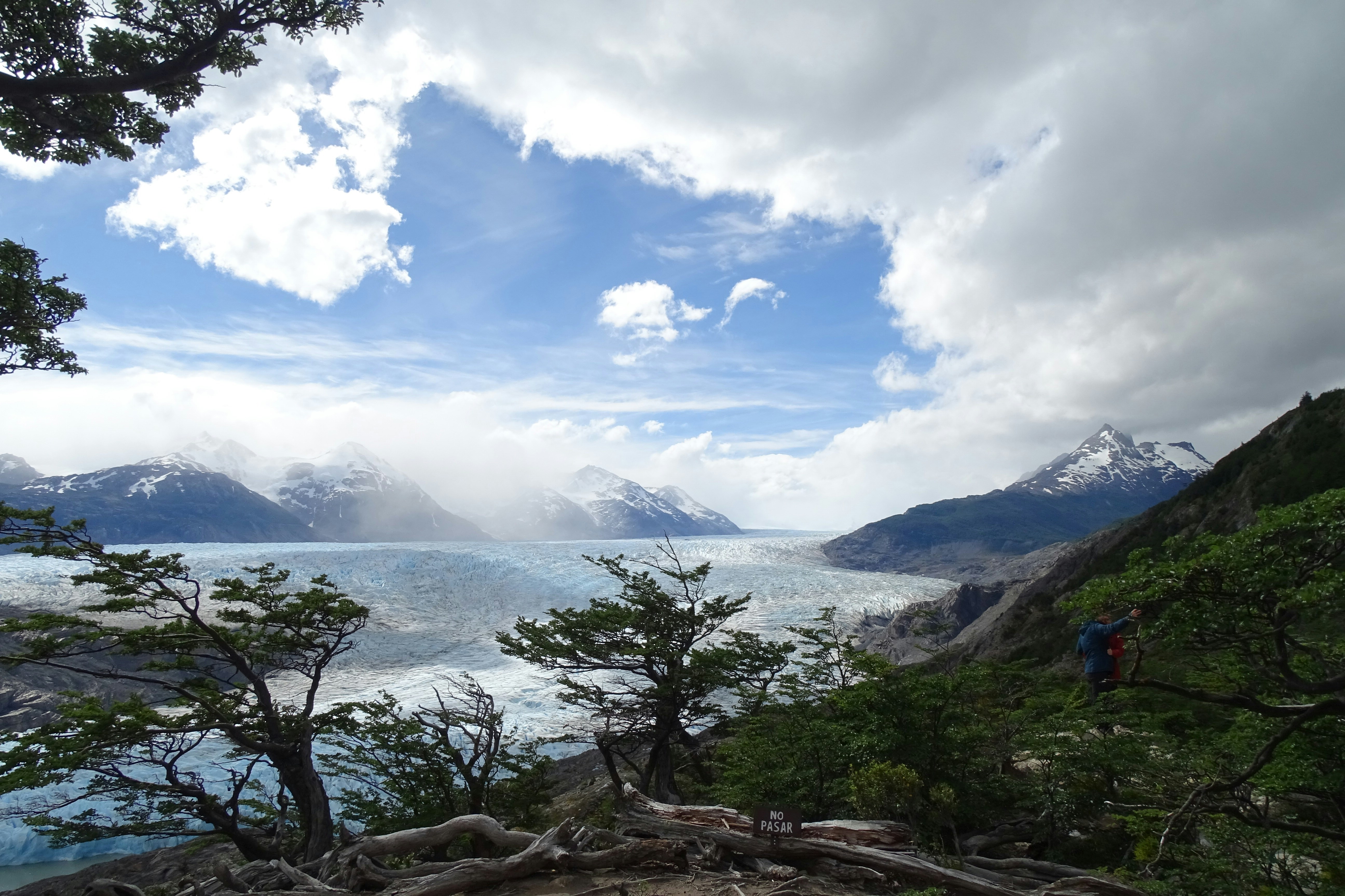 Glacier and mountains under a cloudy sky
