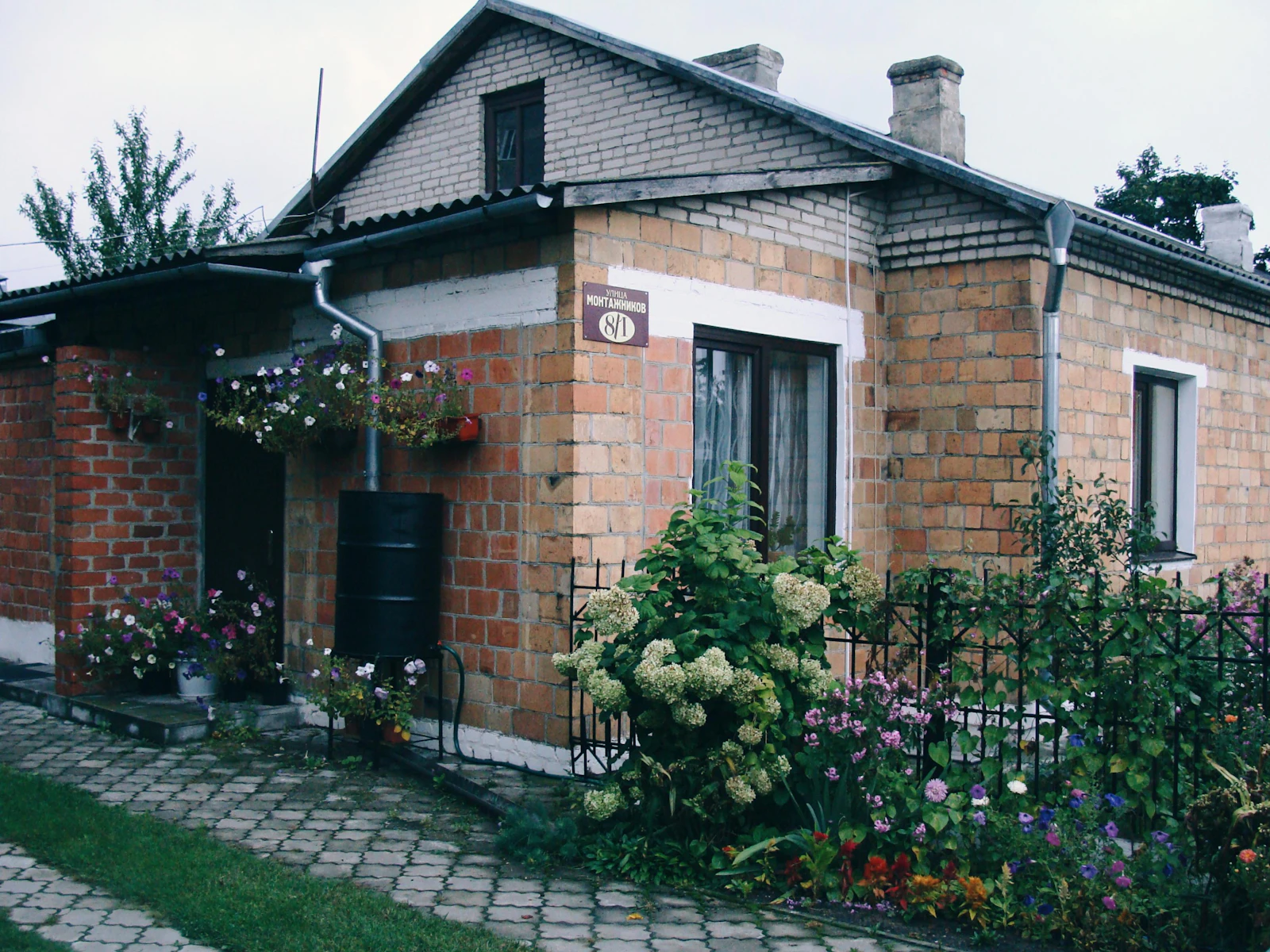 A small home with a garden, the kind of setup a rooftop catchment system is built for