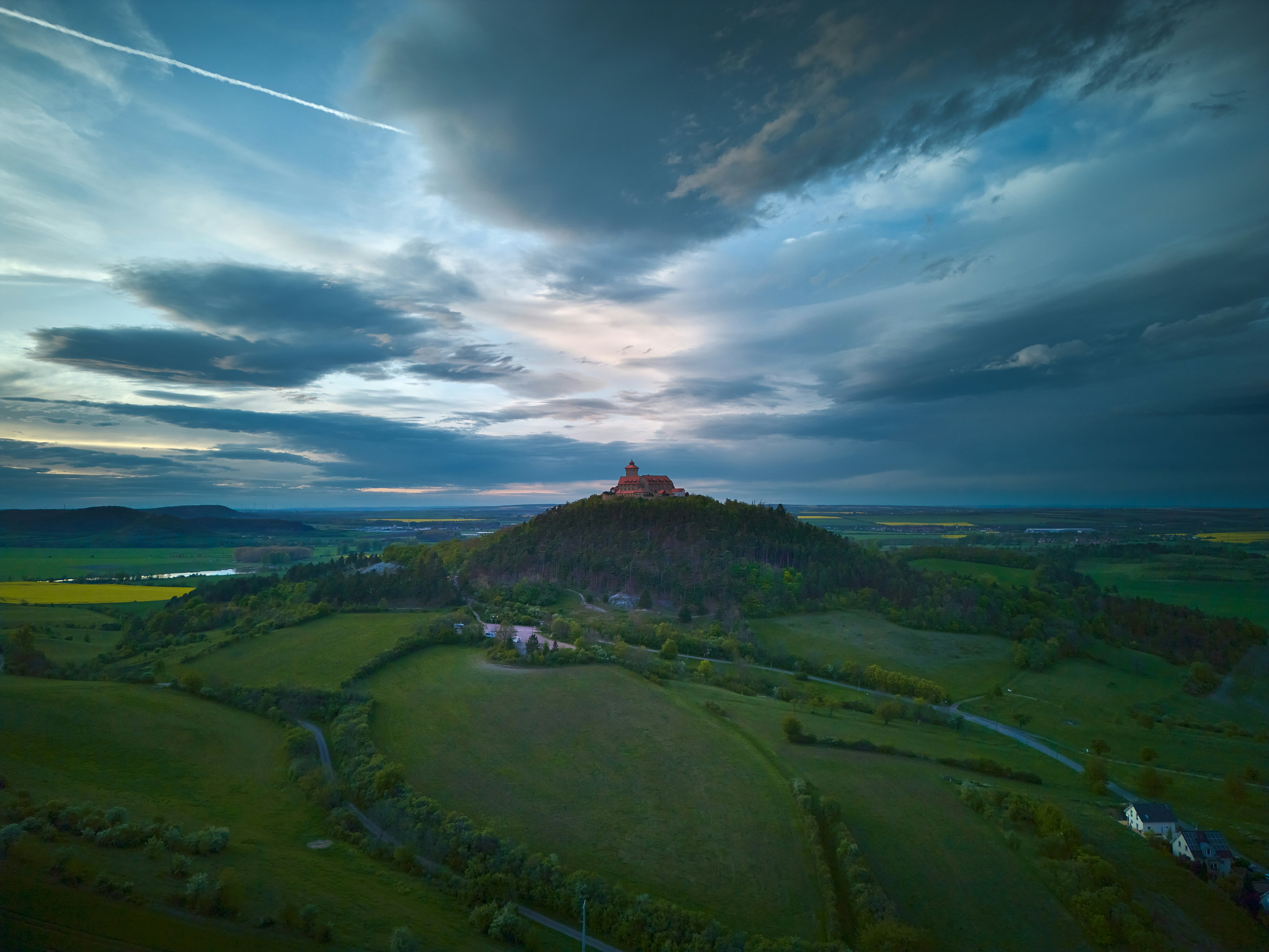 Castle on a hill under dramatic stormy sky