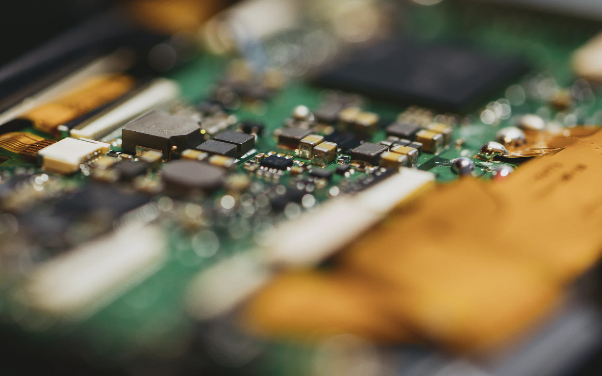 Close-up of a green circuit board with electronic components.