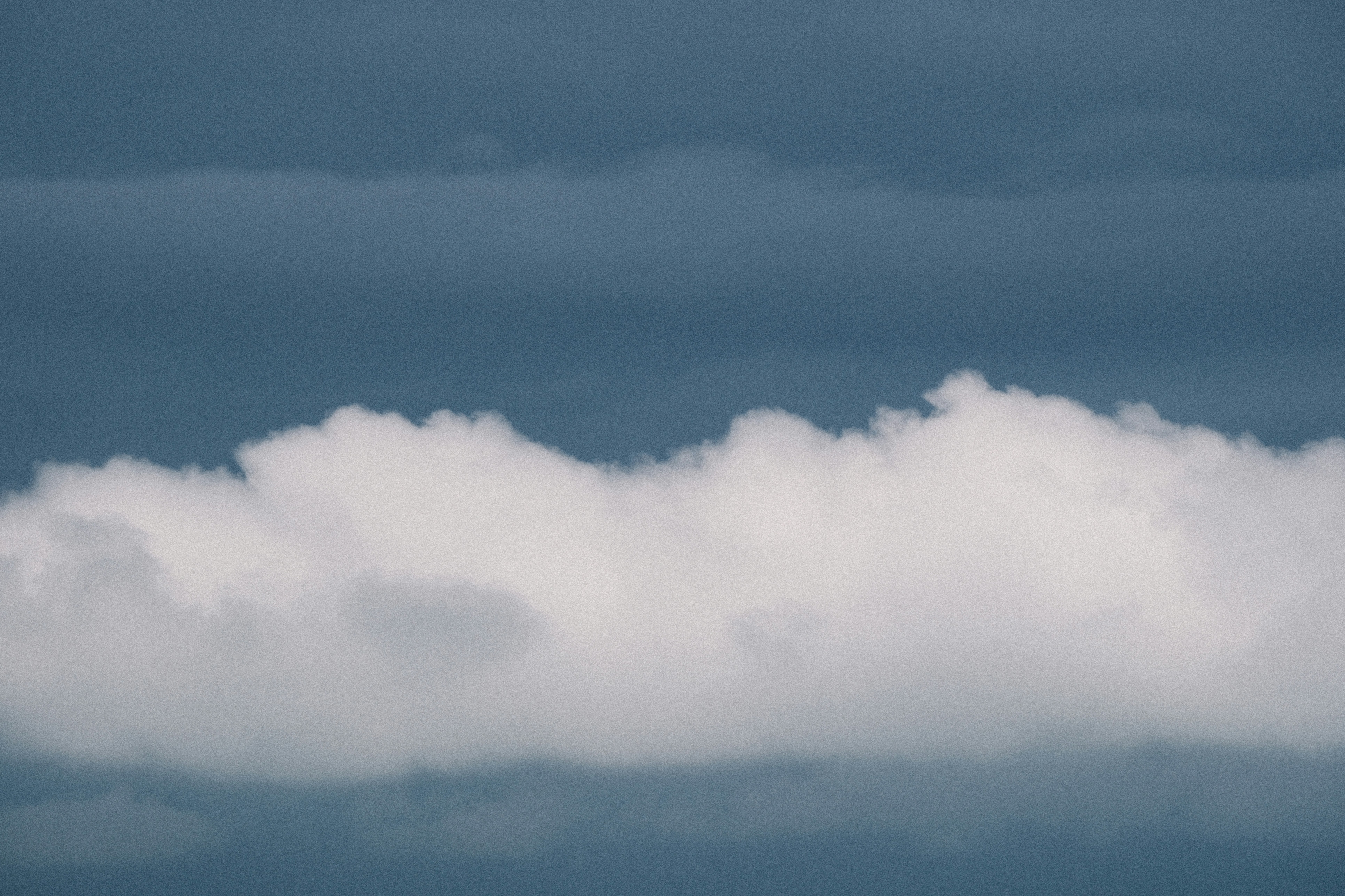 White clouds against a dark blue sky