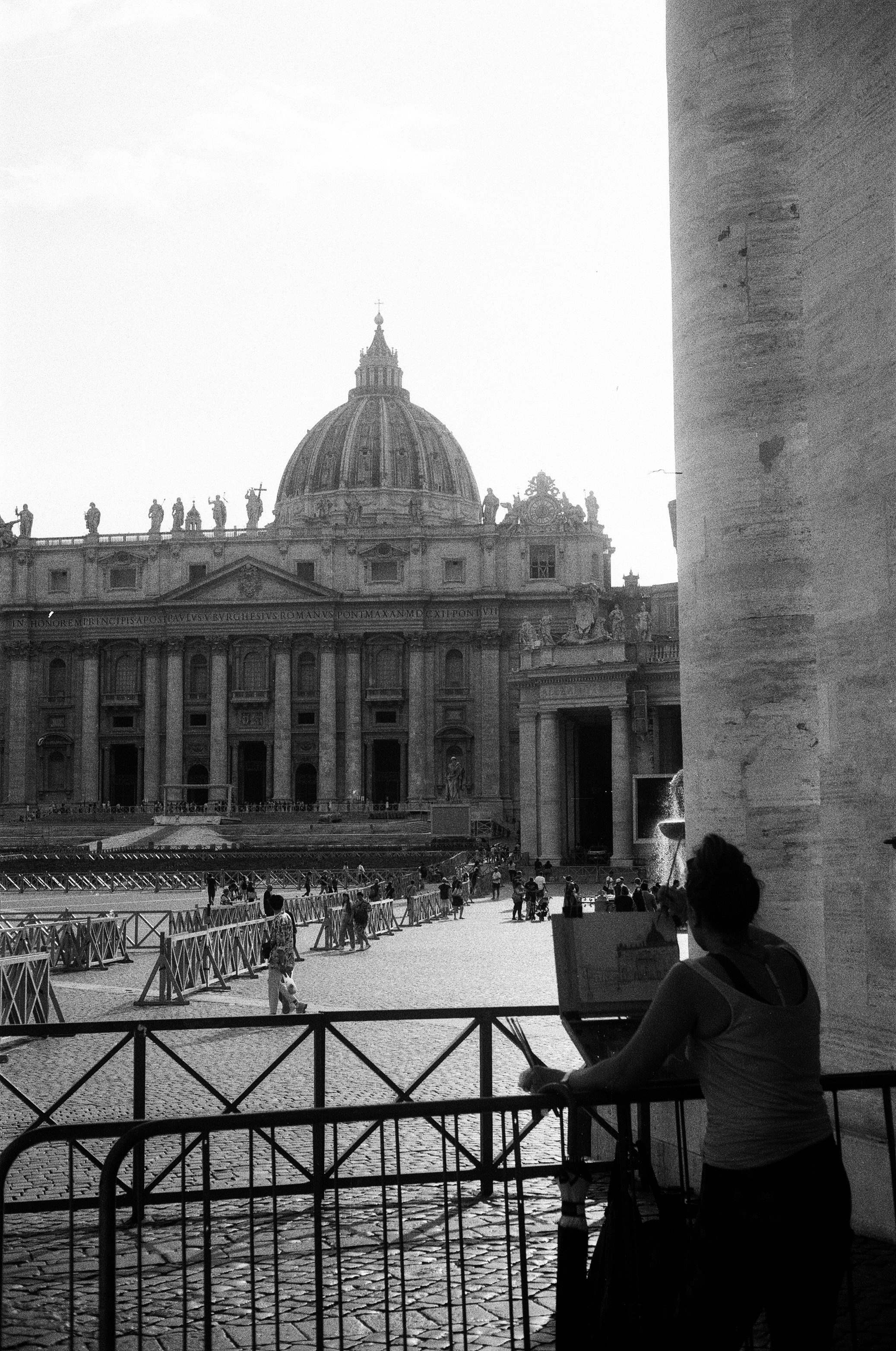 Woman looking at st. peter's basilica in vatican city.
