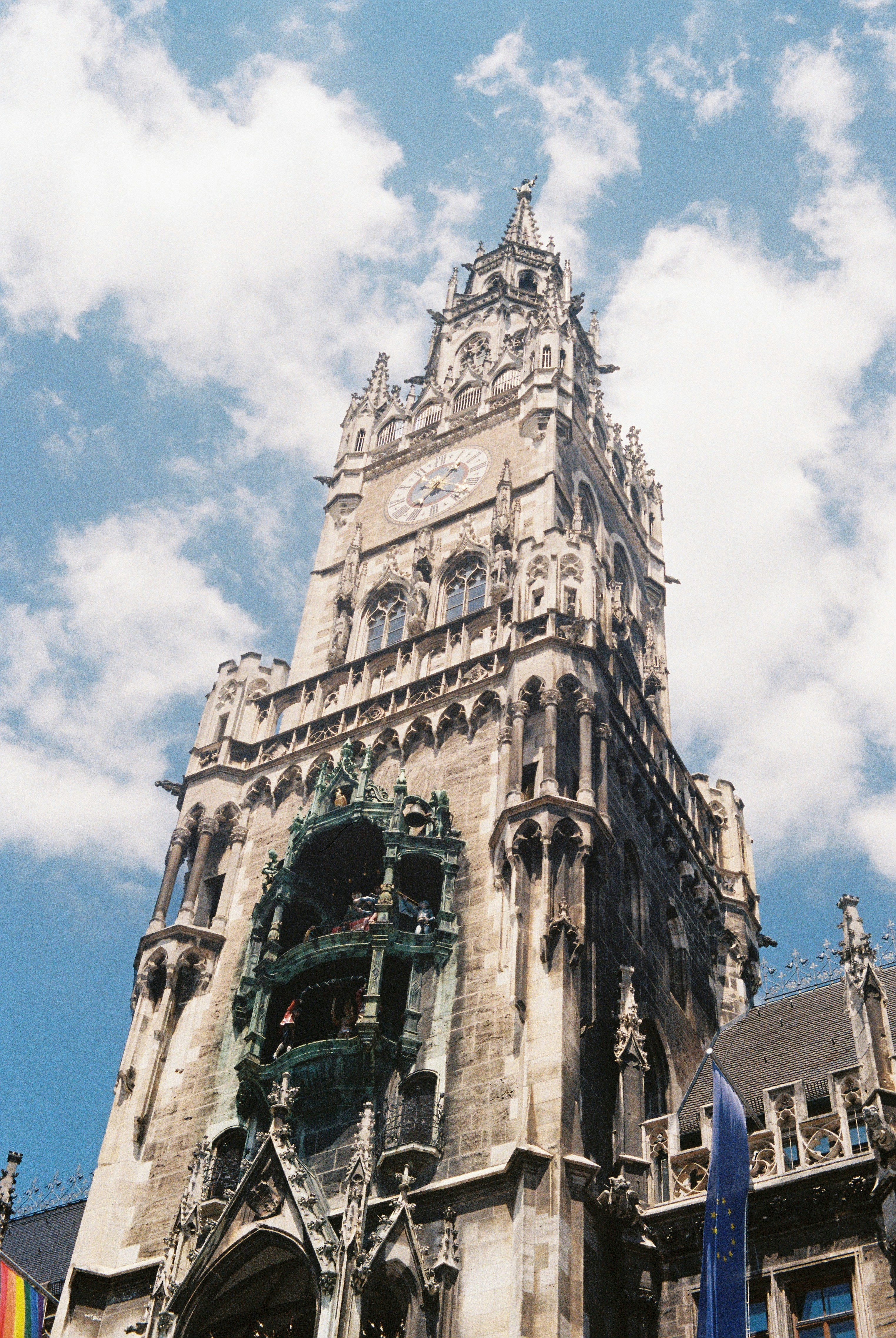 Ornate clock tower against a cloudy blue sky