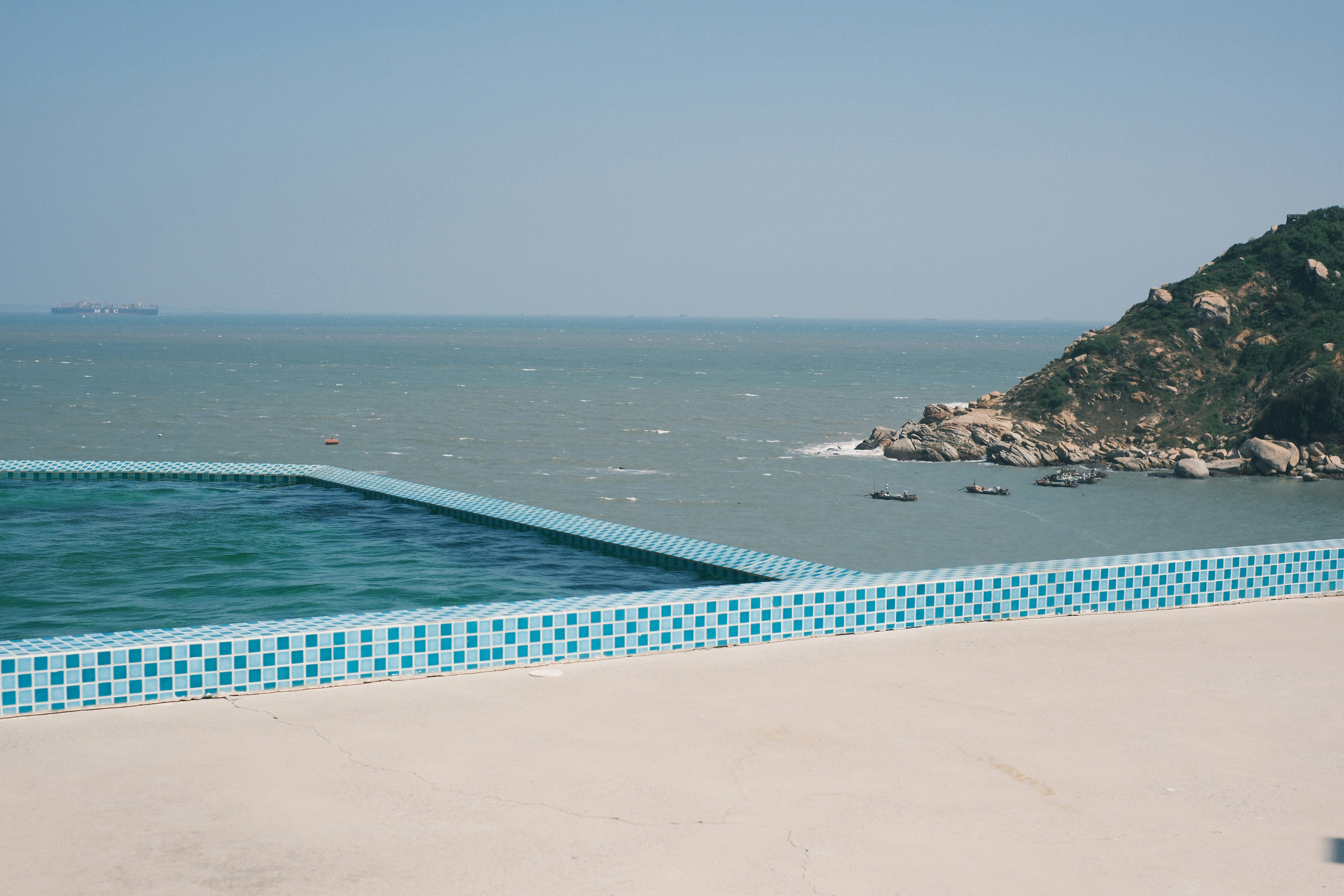 Infinity pool overlooking the ocean and rocky coast