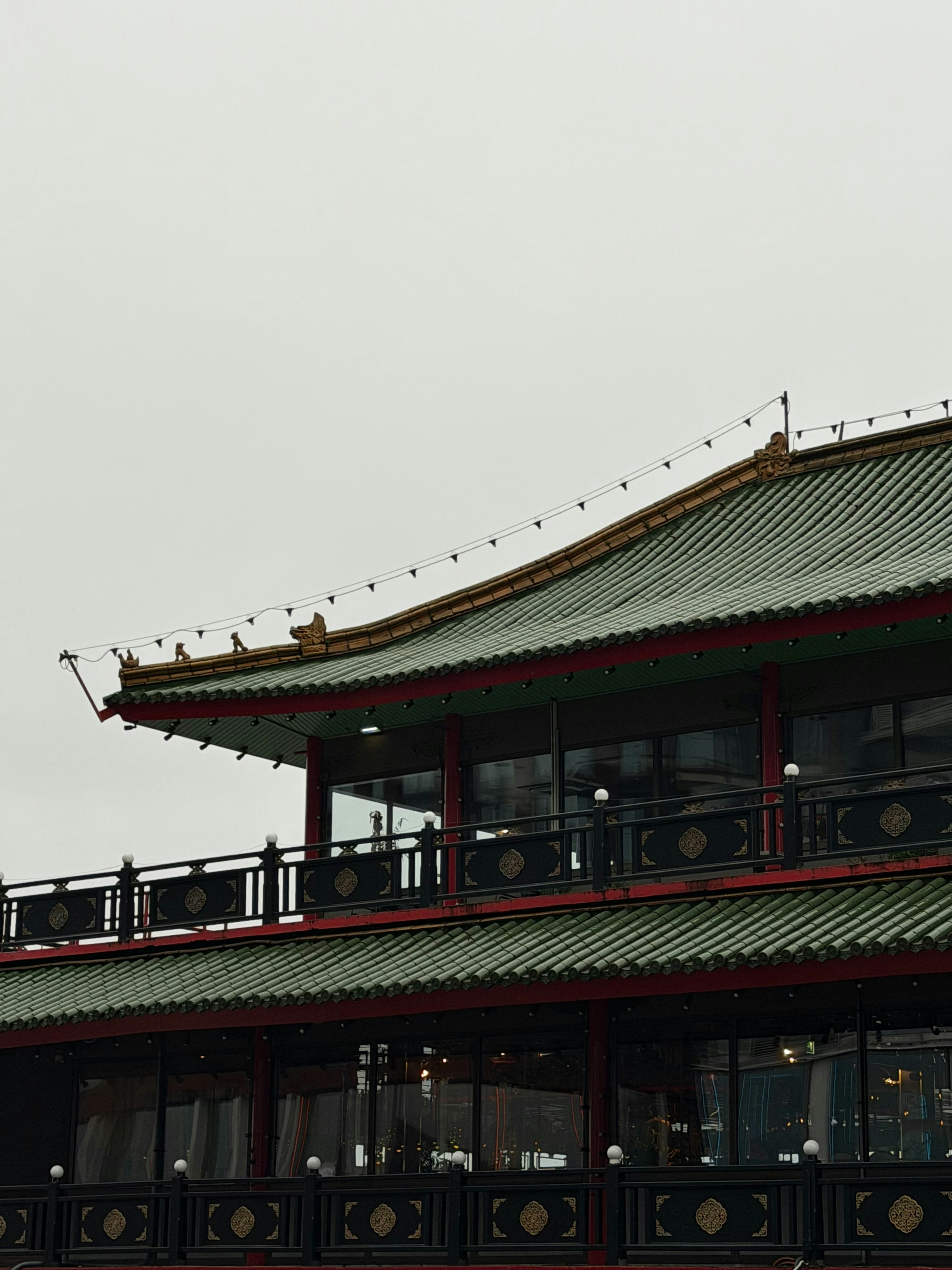 Traditional east asian building with green tiled roof
