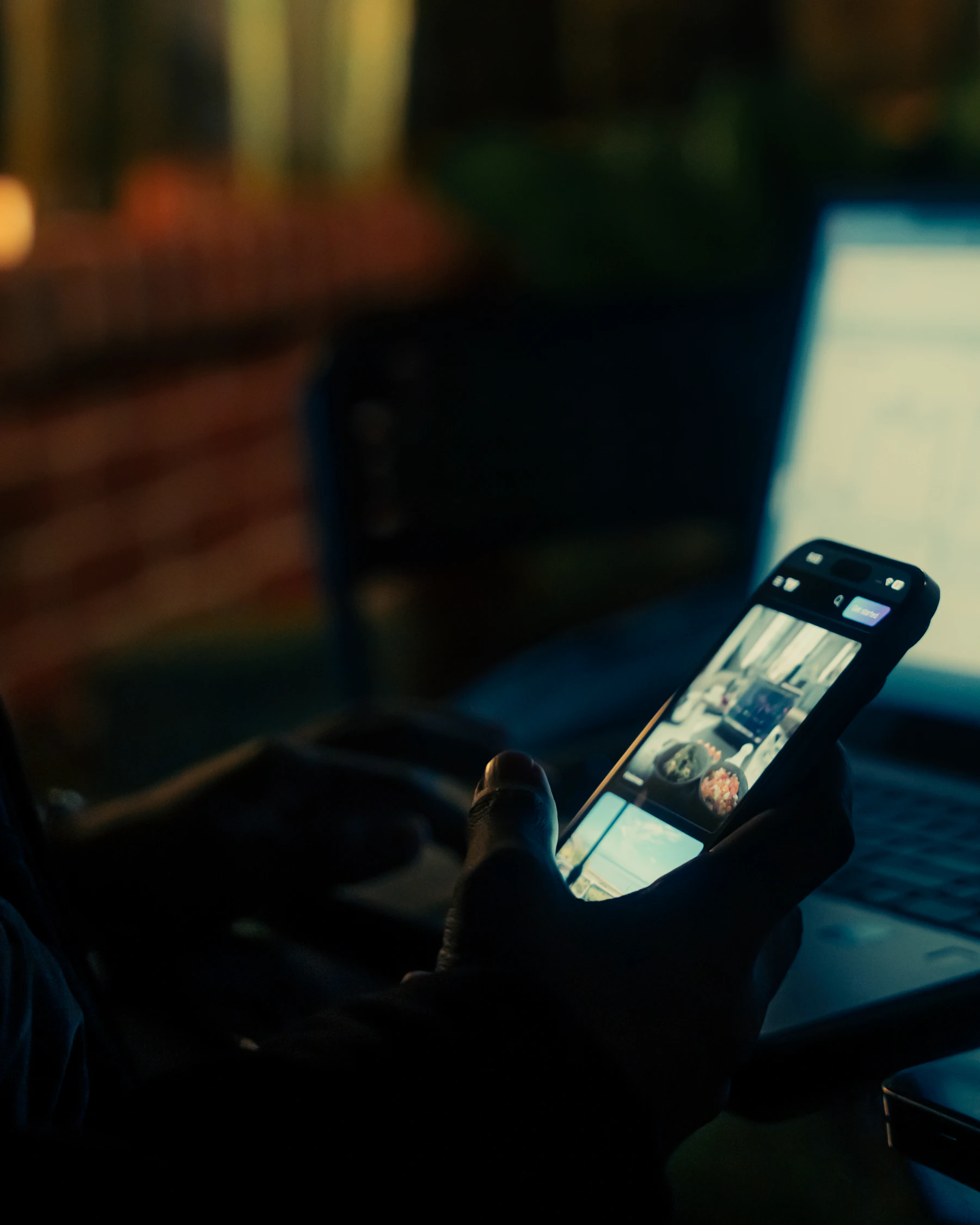 Person using a smartphone and laptop