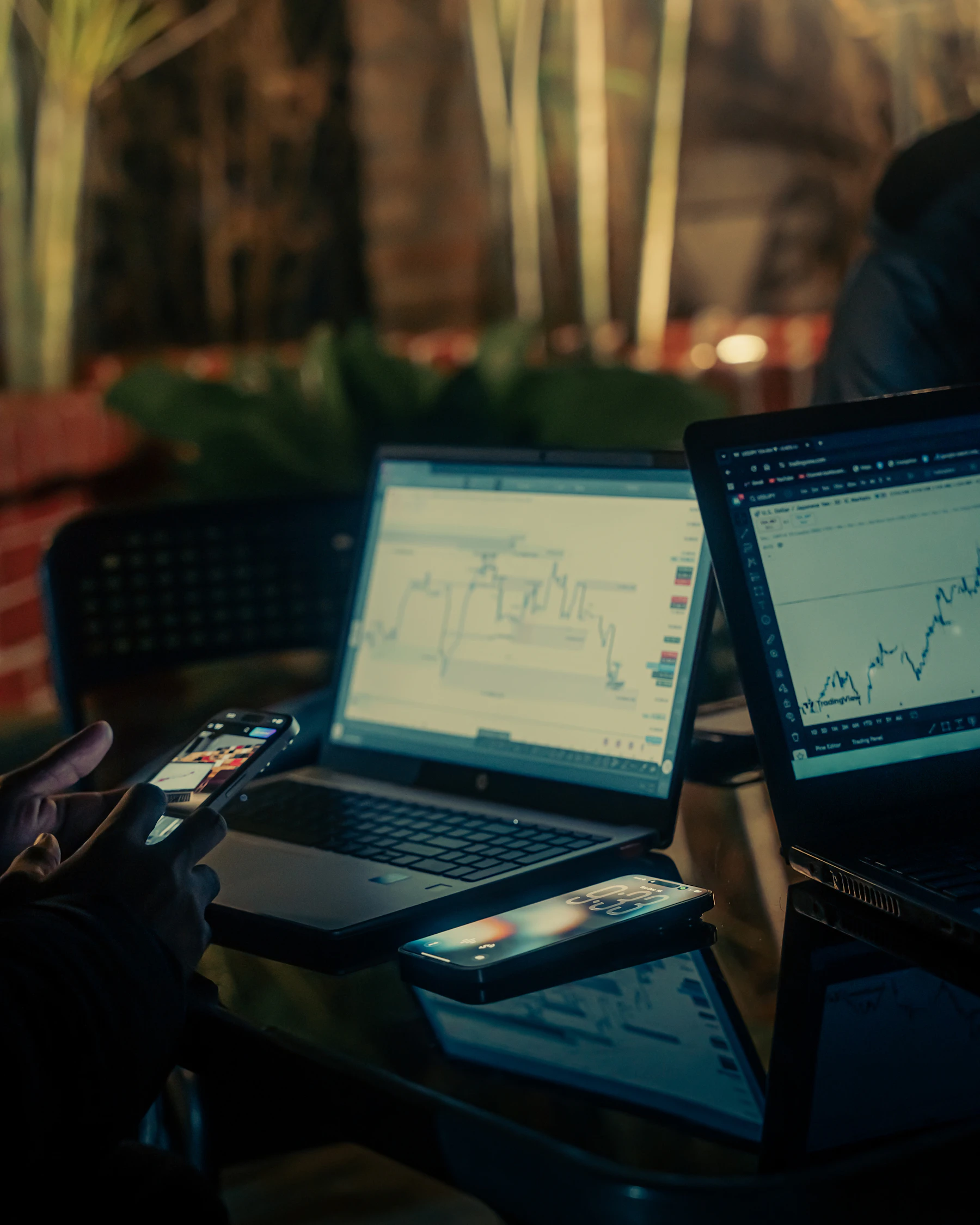 Financial trading workspace with charts on laptops