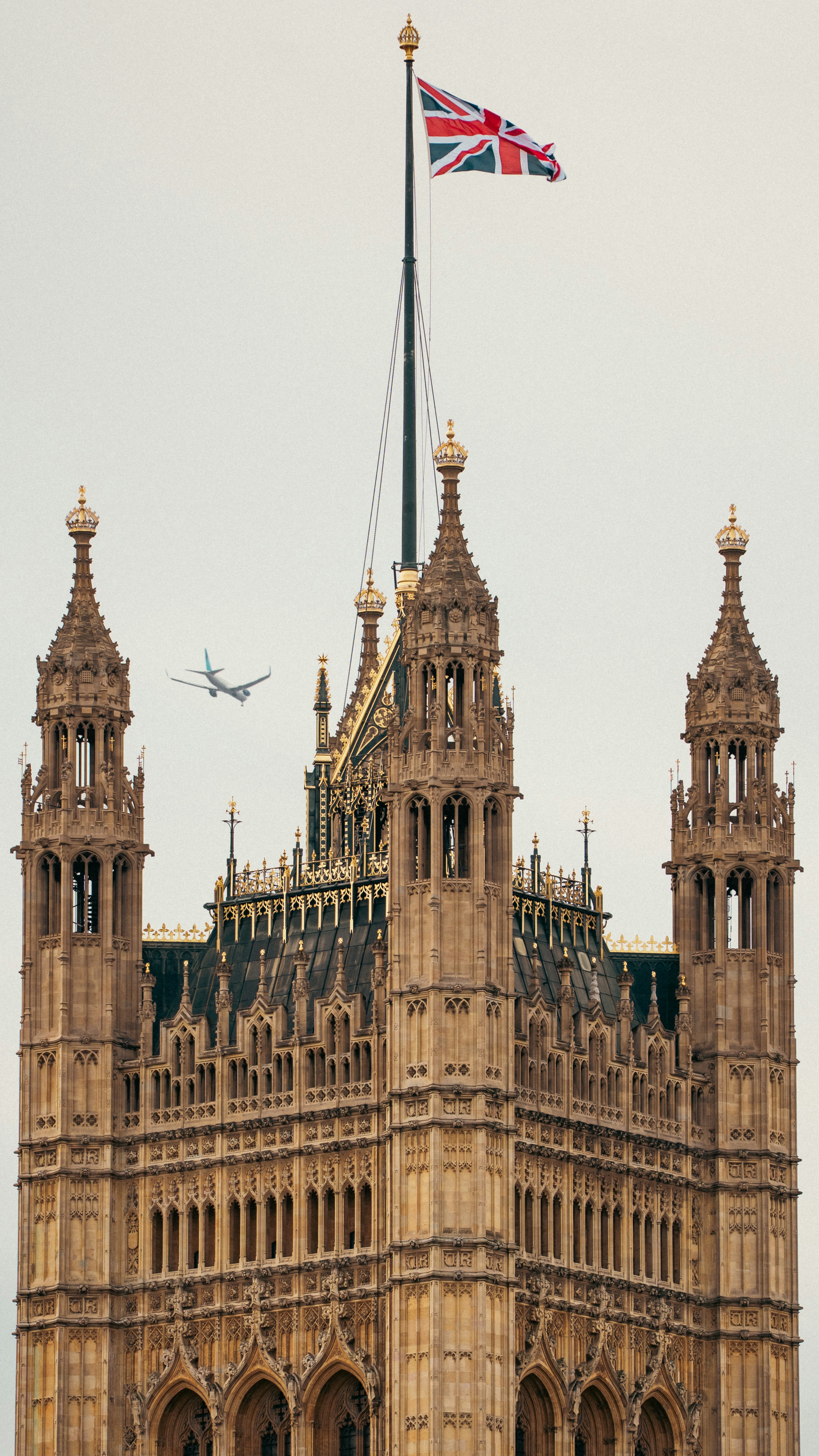 Big ben and union jack flag with airplane flying by