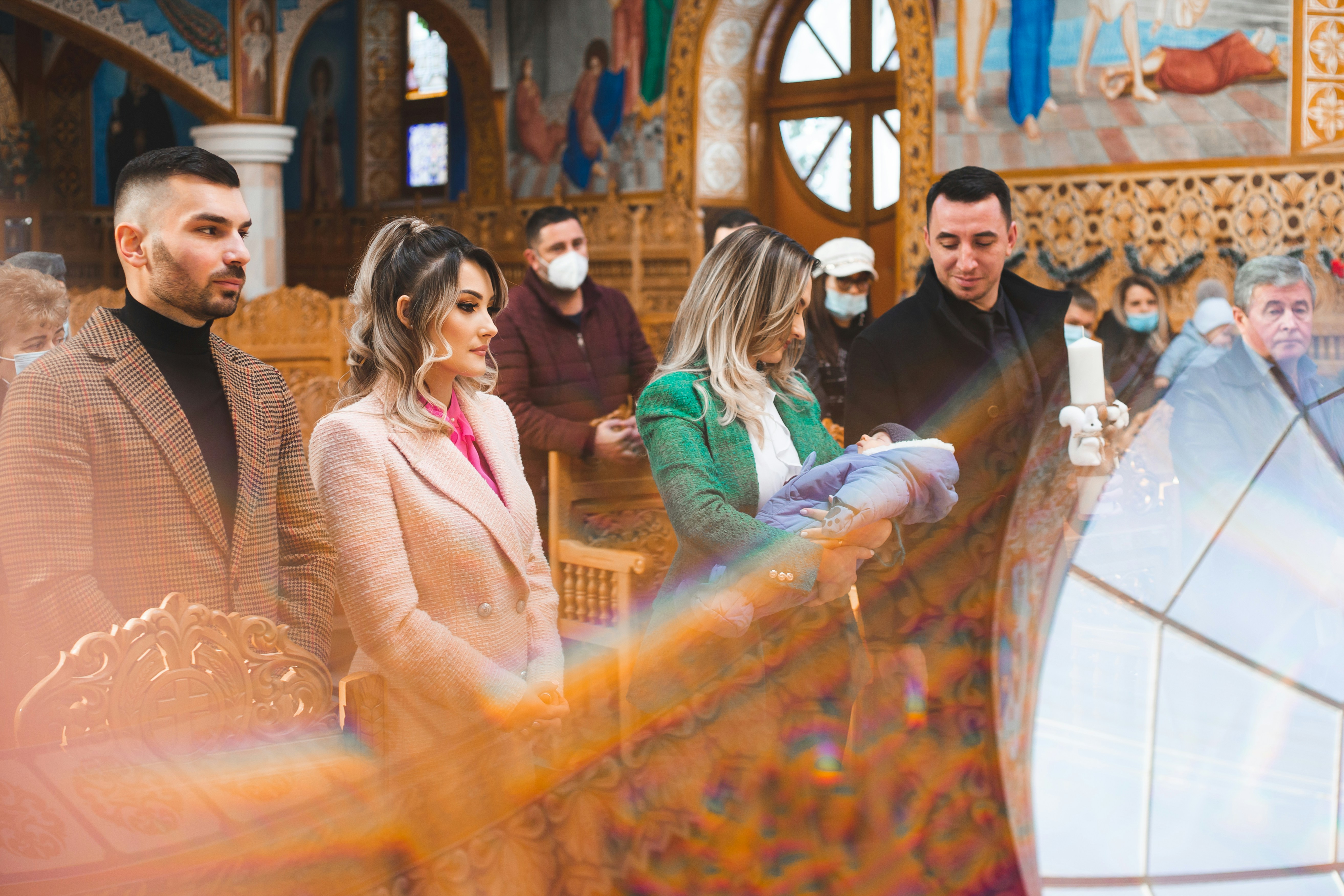 Family attending a religious ceremony with a baby.
