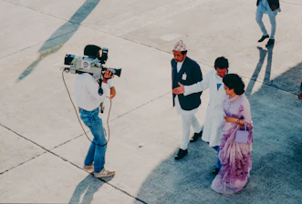 Cameraman films dignitaries arriving at event