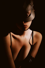 Woman wearing a dark mask and lingerie