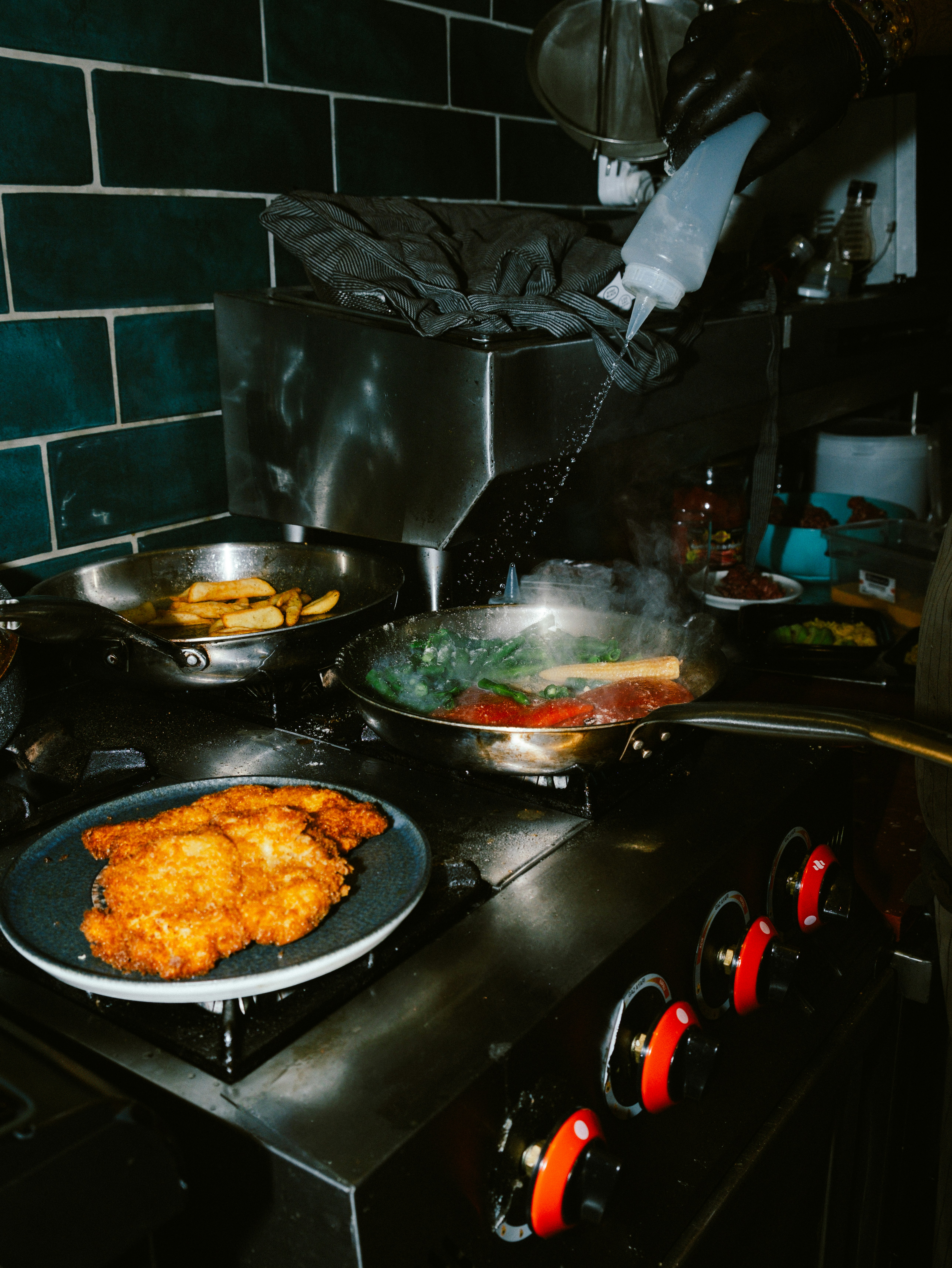 Chef prepares food in a busy kitchen