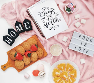 Cookies, fruit, and marshmallows with "food is love" sign