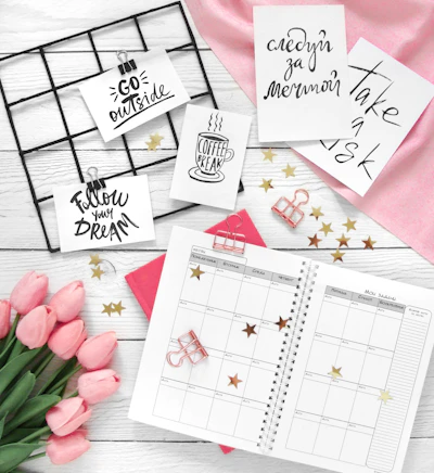 Desk flat lay with tulips, planner, and inspirational notes