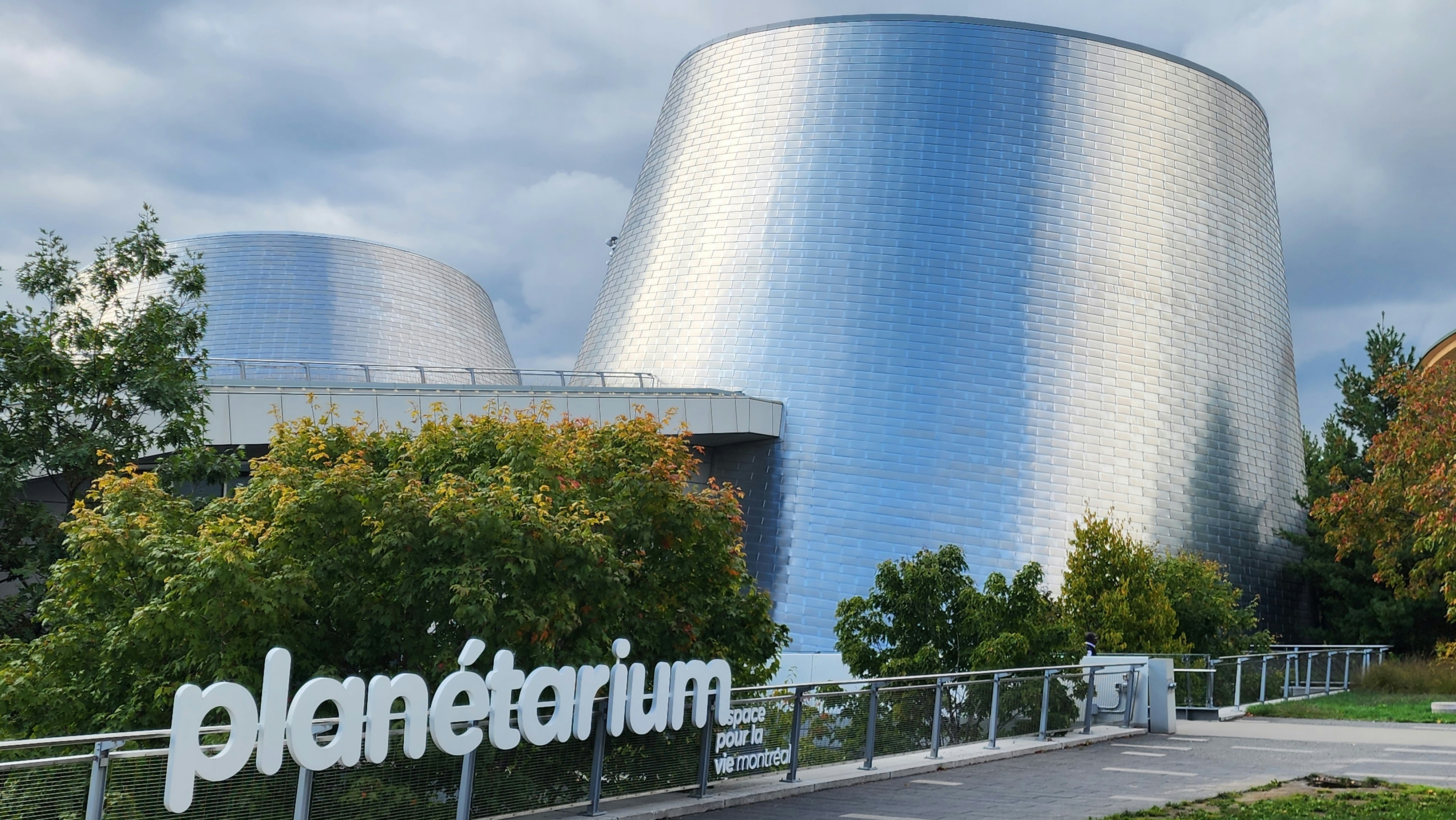 Modern planetarium building with signage