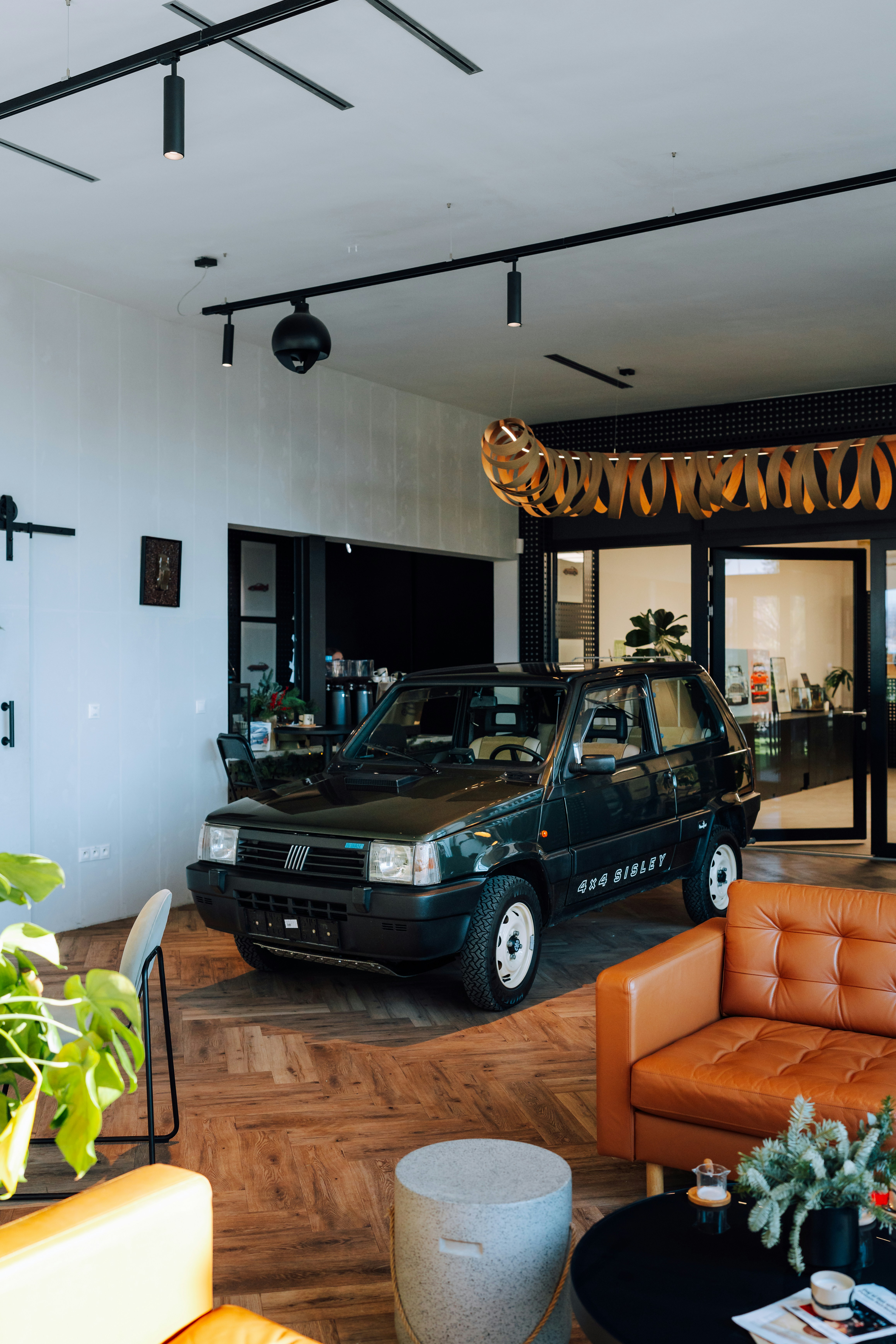 Dark green vintage car parked indoors with modern interior
