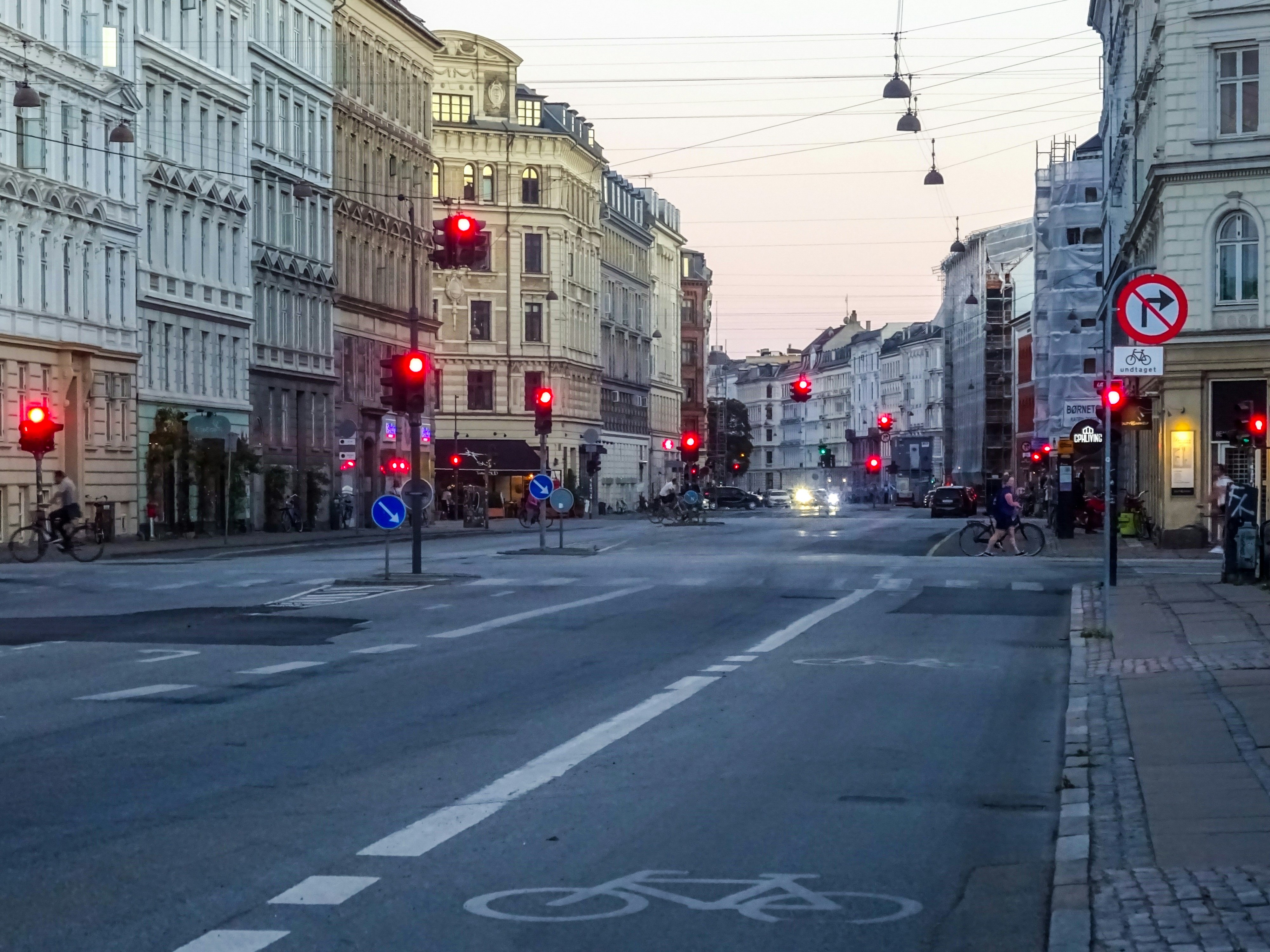 City street with red traffic lights at dusk