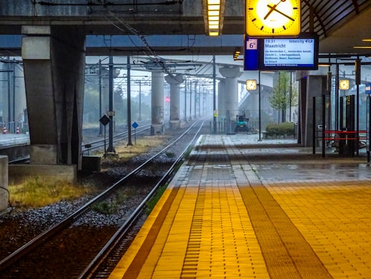 Train station platform with tracks and overhead clock