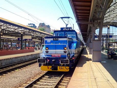 Blue and white electric train at a station platform.