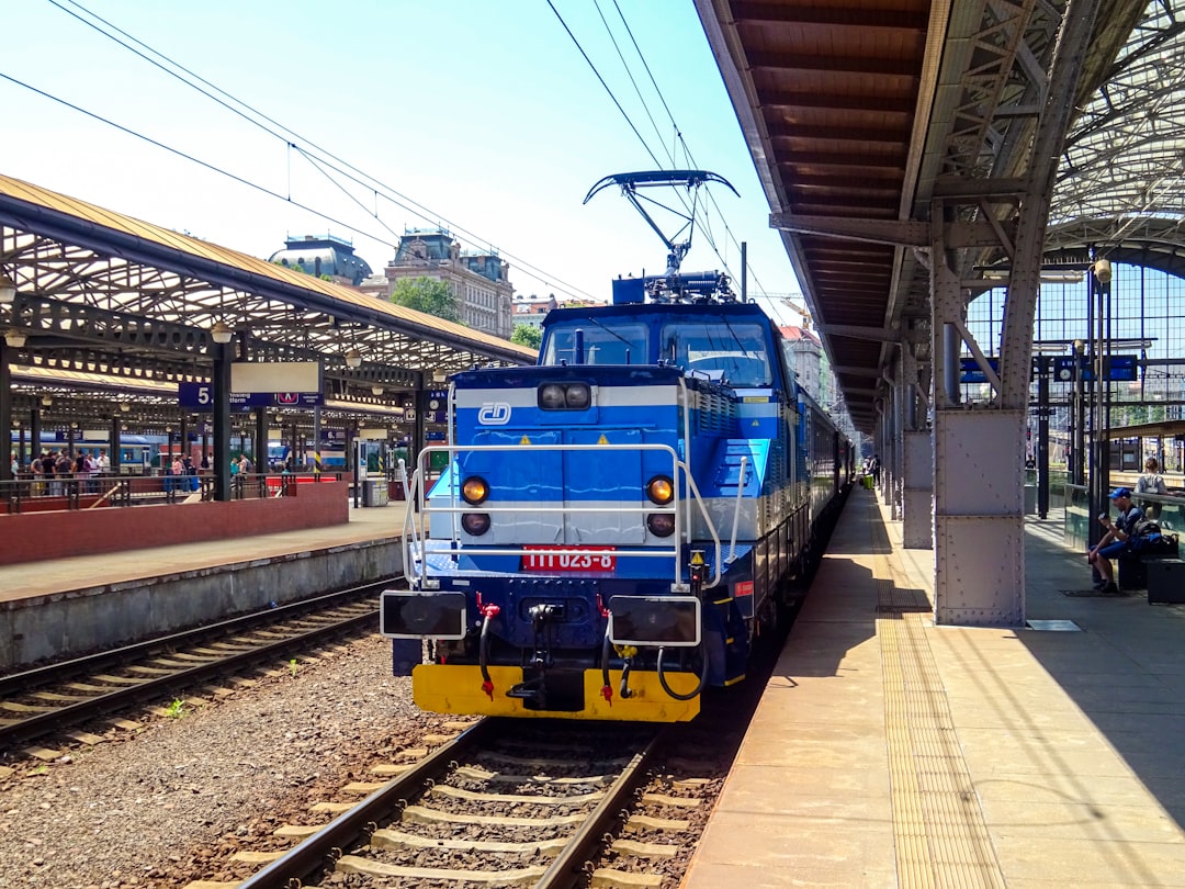 Blue and white electric train at a station platform.