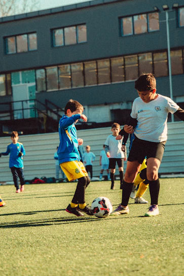 Boys playing soccer on a field.