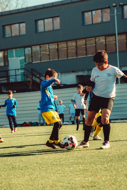 Children playing soccer outdoors - team sports neurodivergent children Sydney