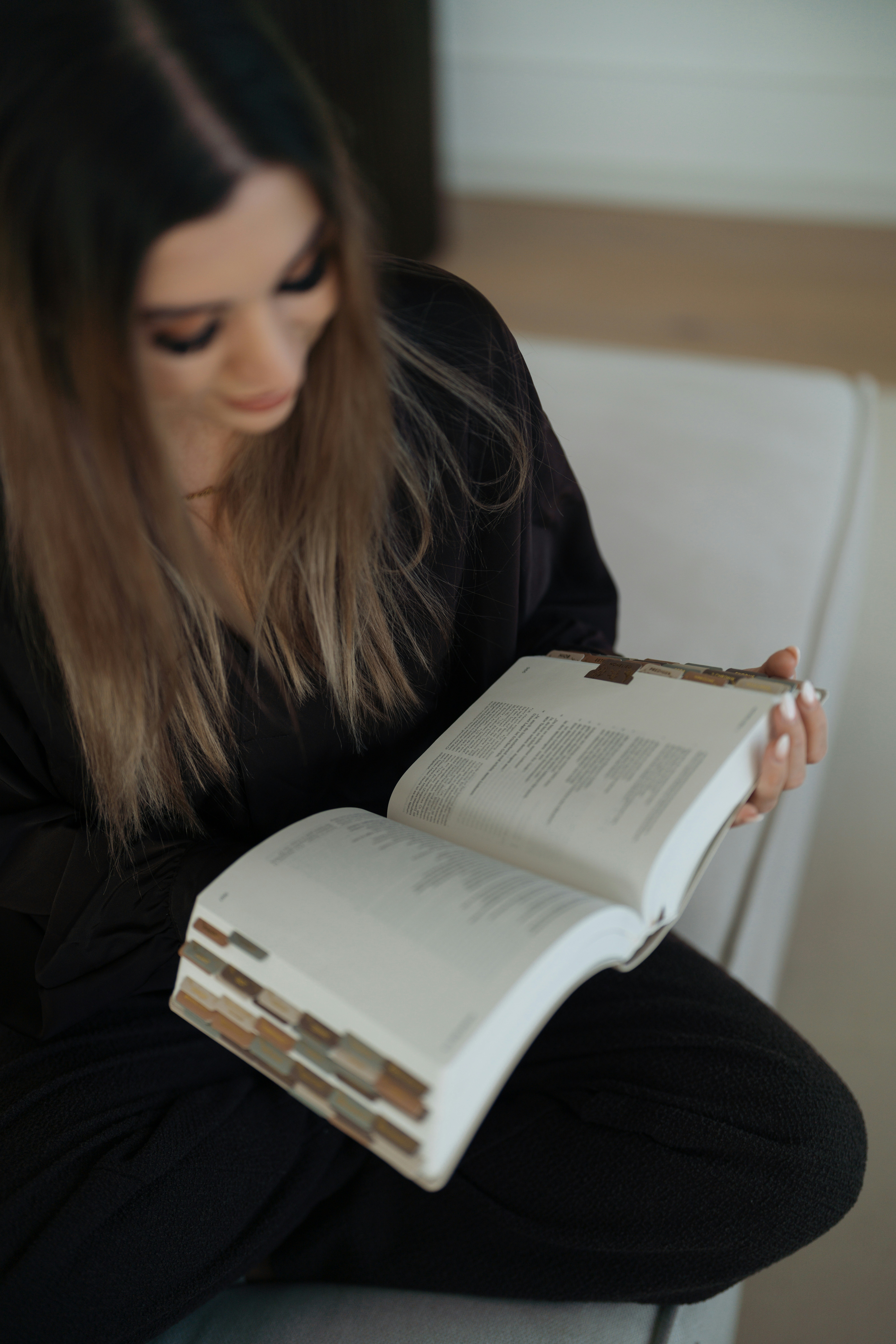 A woman reading a large open book