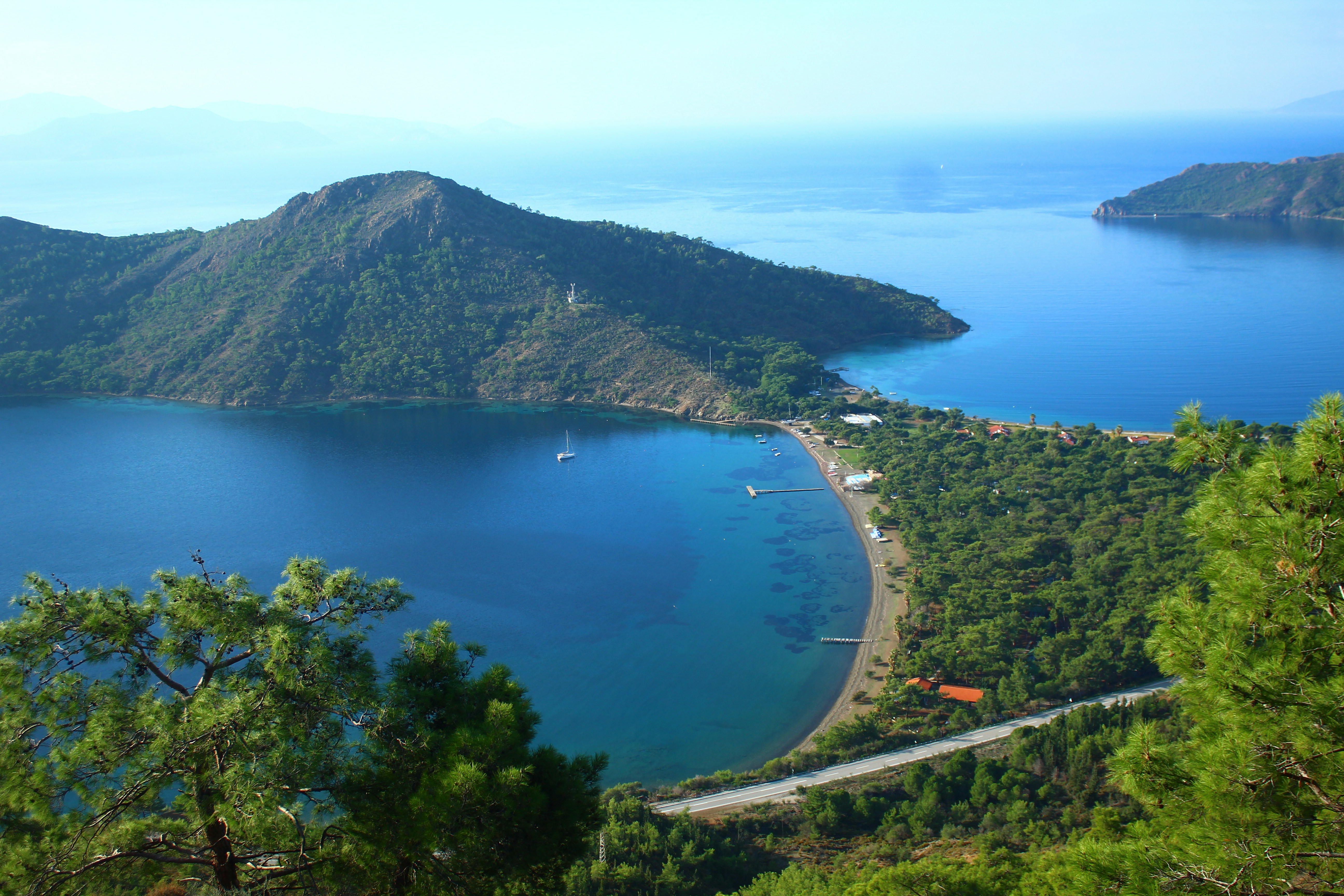 Coastal landscape with calm blue water and green hills