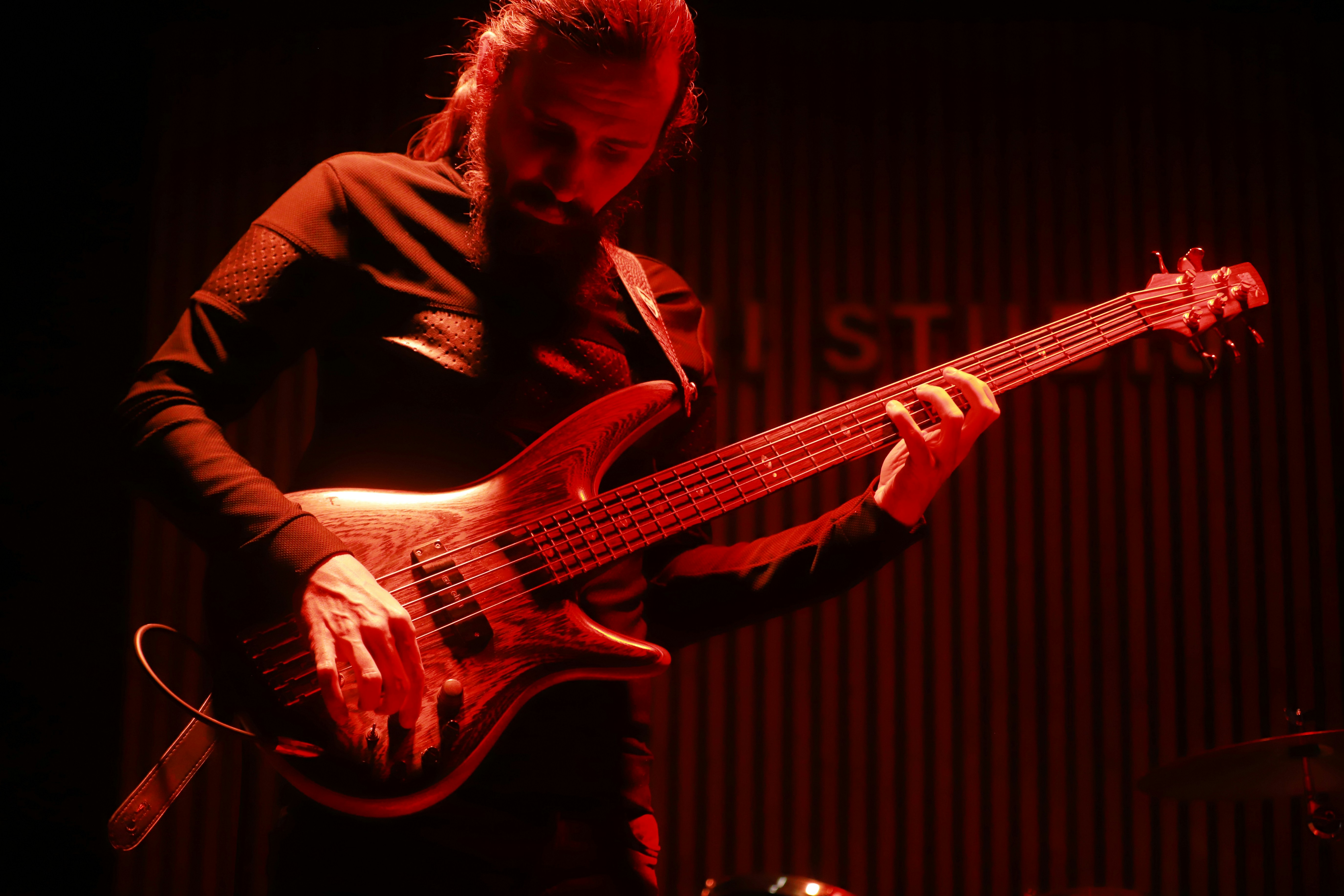 Man playing a bass guitar on stage