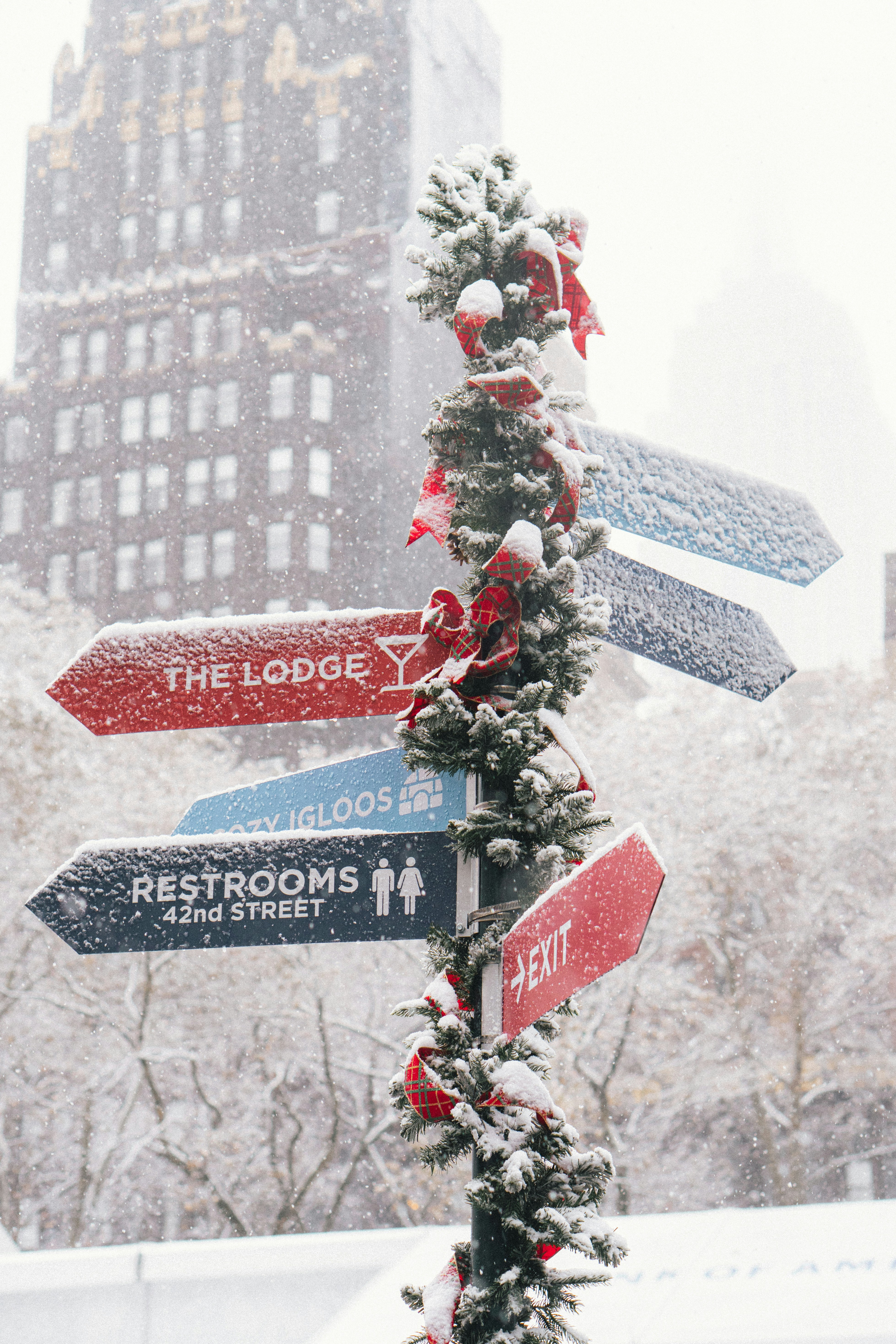 Snowy directional signs decorated for christmas holidays