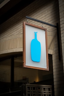 Blue bottle coffee sign on brick building