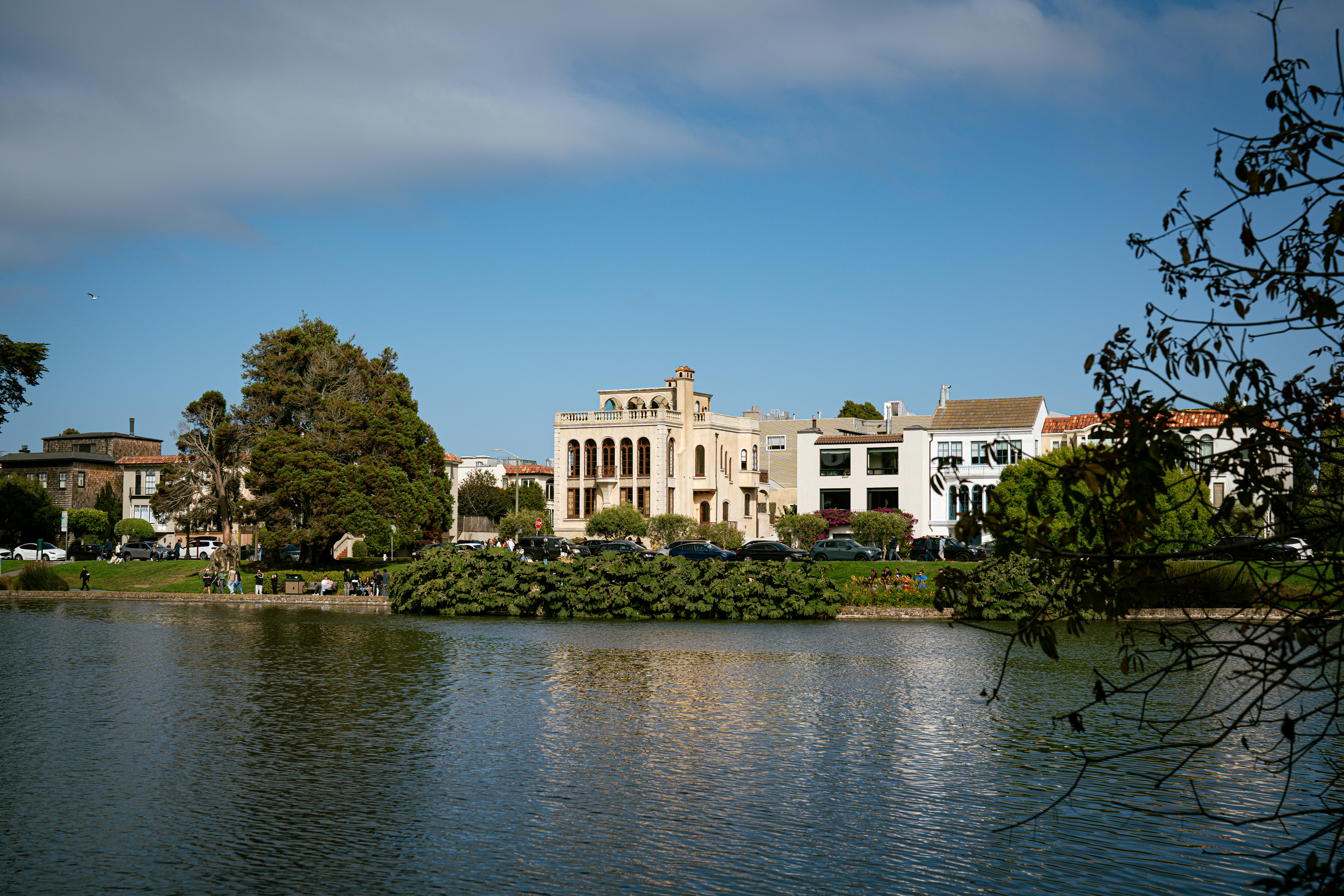 Buildings reflected in the calm lake water.