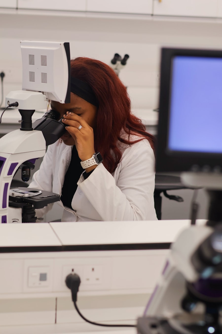 Scientist examining tissue slides under a modern laboratory microscope