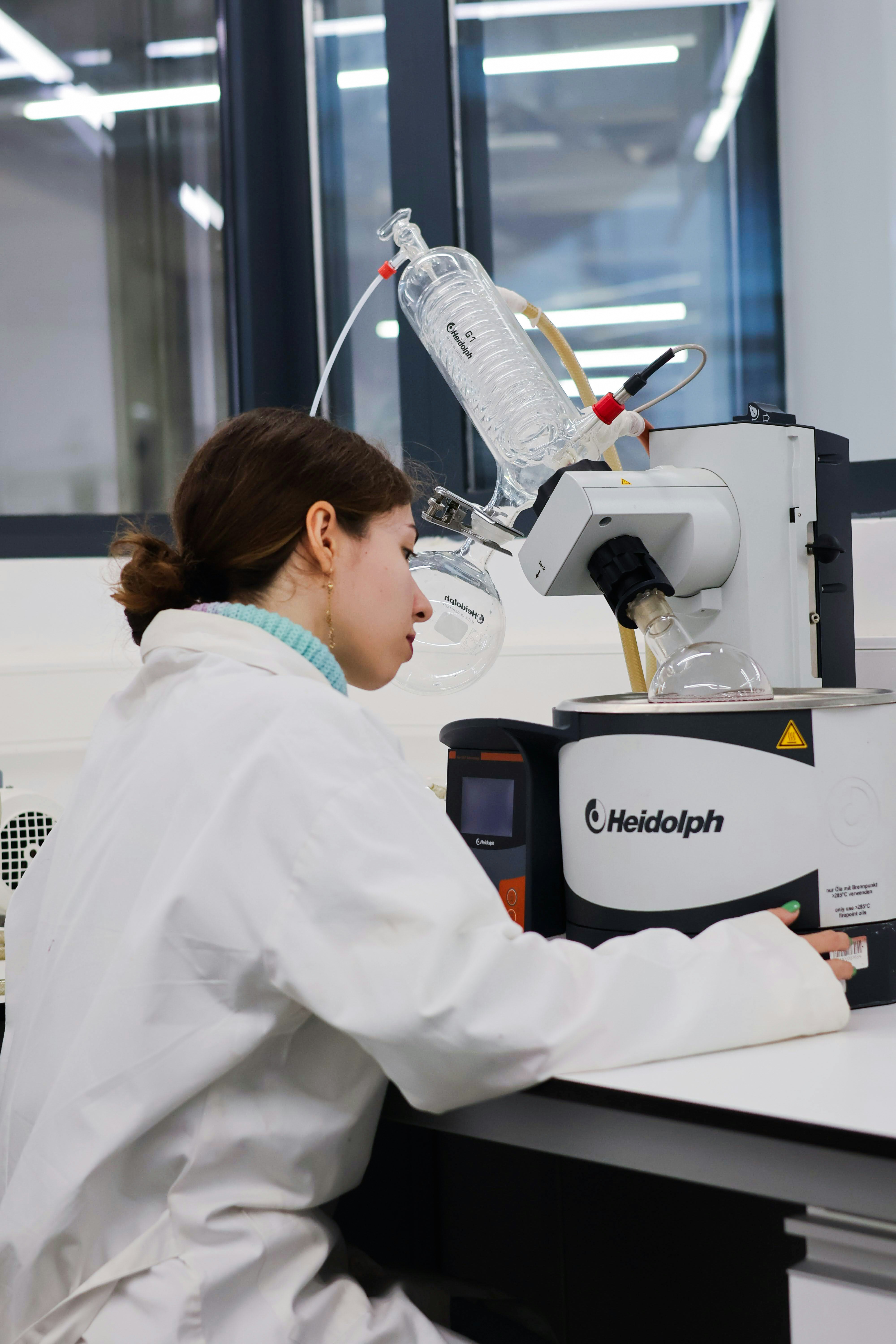 Scientist operating rotary evaporator in laboratory
