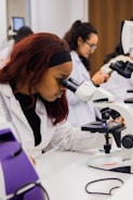Young woman using a microscope in a science lab.
