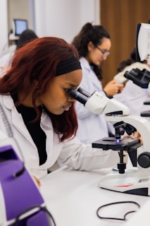 Young woman using a microscope in a science lab.