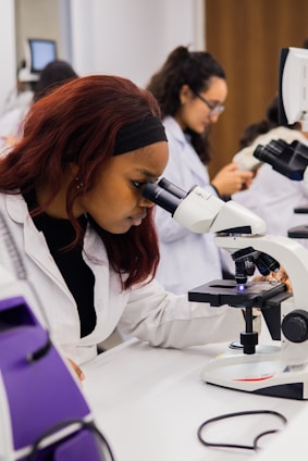 Young woman using a microscope in a science lab.