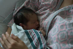 Newborn baby sleeping peacefully on a parent.