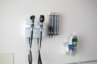 Medical diagnostic tools mounted on a wall.