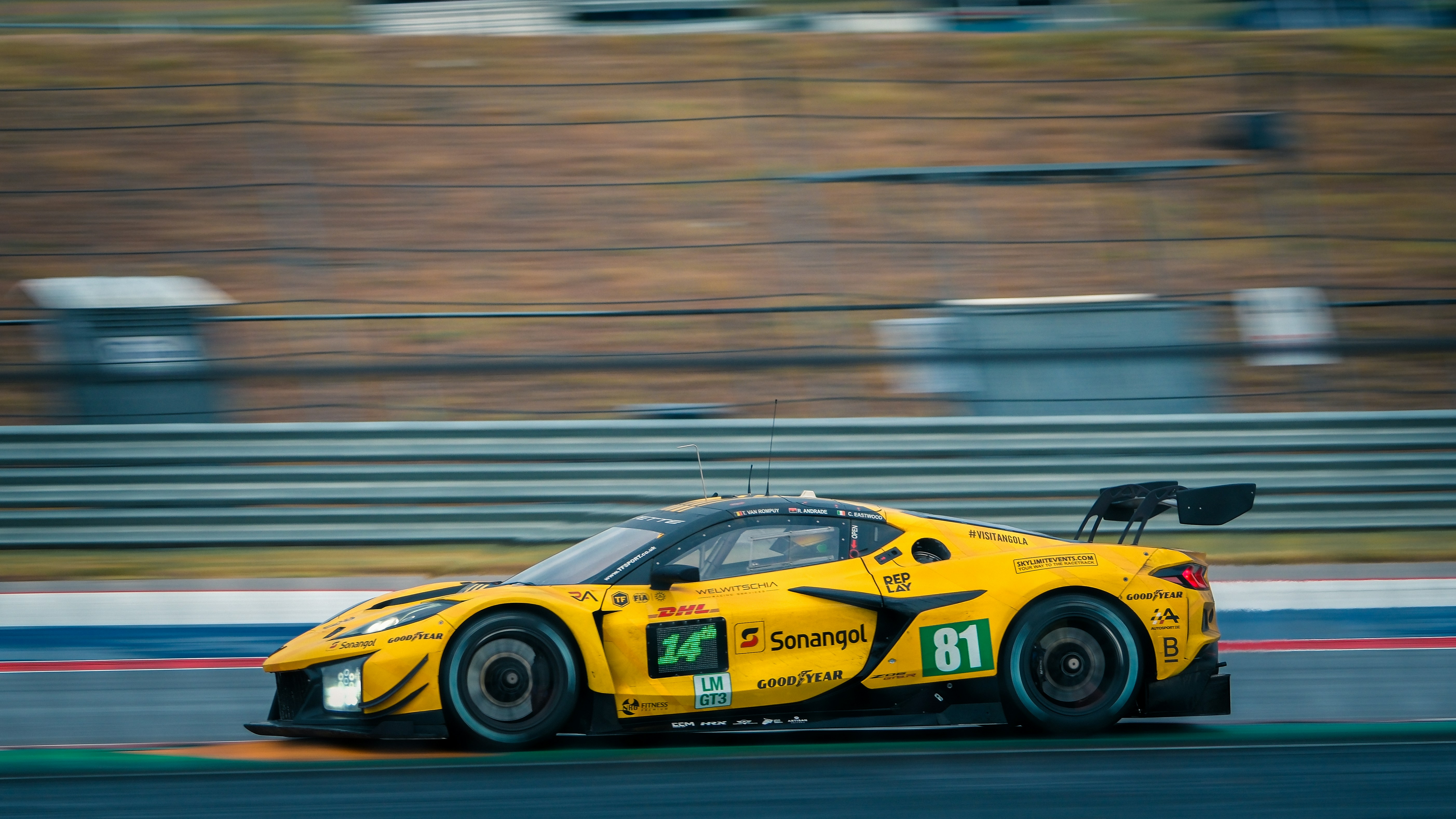 Yellow race car speeding on a track